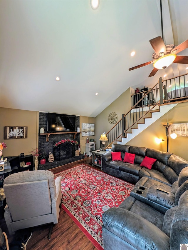 living room with ceiling fan, recessed lighting, wood finished floors, stairs, and a brick fireplace