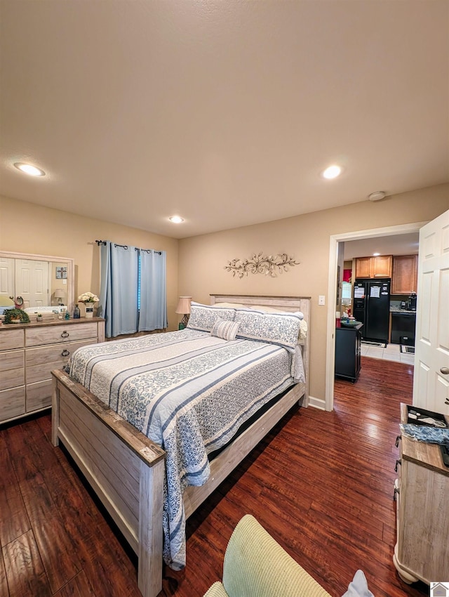 bedroom with dark wood-style floors, recessed lighting, and freestanding refrigerator