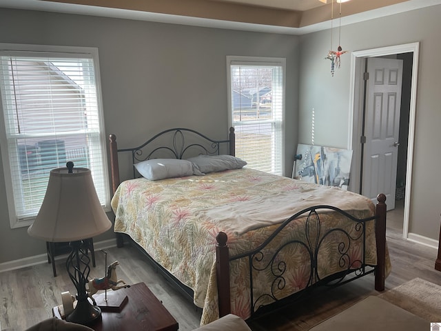 bedroom with wood finished floors and baseboards