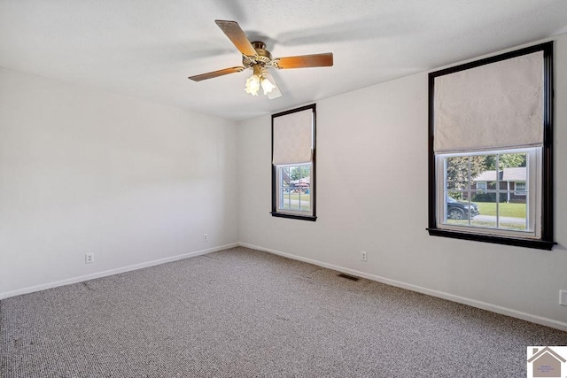 unfurnished room with baseboards, visible vents, ceiling fan, and carpet flooring