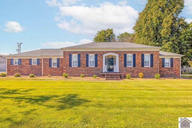 ranch-style house with crawl space, a shingled roof, a front lawn, and brick siding