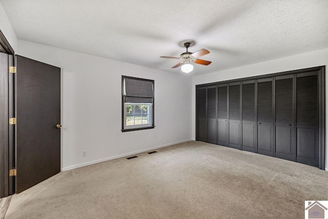 unfurnished bedroom featuring carpet, visible vents, and baseboards