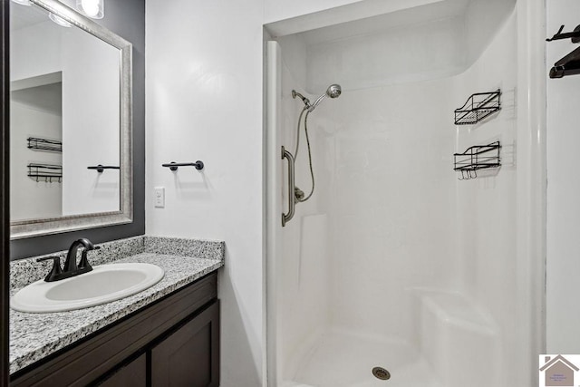 bathroom featuring a stall shower and vanity