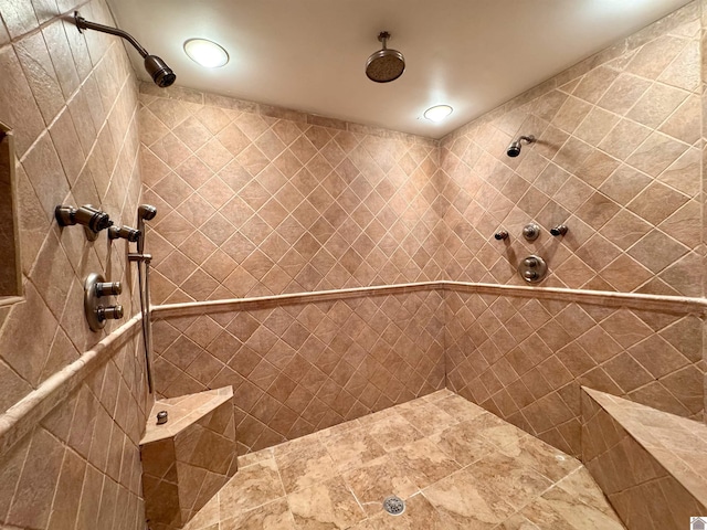 full bath with a tile shower