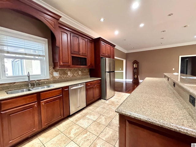 kitchen with crown molding, light tile patterned floors, stainless steel appliances, decorative backsplash, and a sink