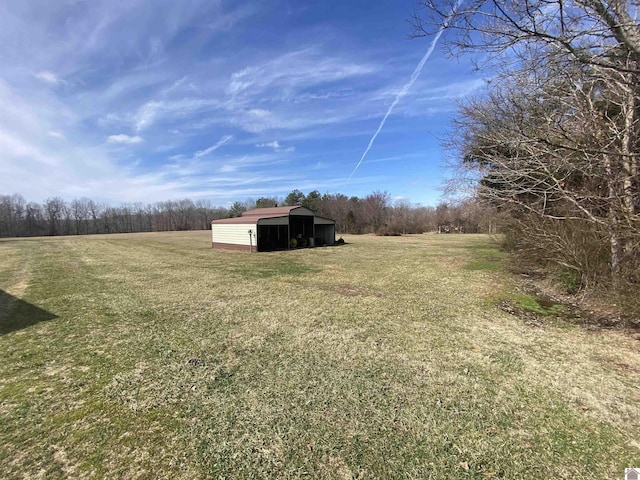 view of yard featuring an outbuilding and a rural view