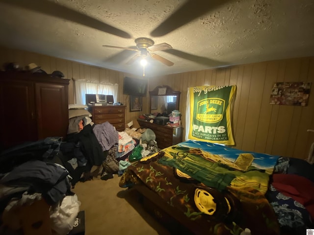 bedroom featuring a ceiling fan, carpet flooring, and a textured ceiling