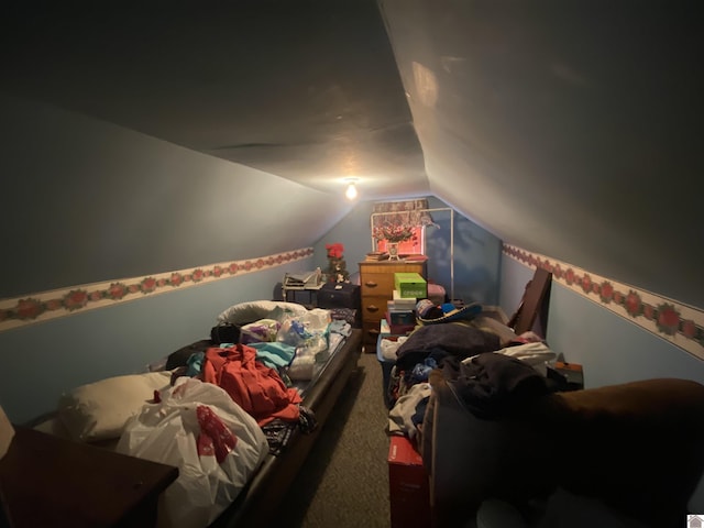 bedroom featuring vaulted ceiling and carpet