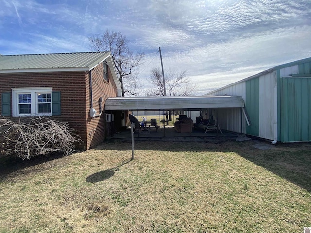 exterior space featuring metal roof, brick siding, and a lawn