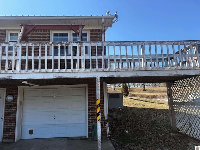 exterior space with an attached garage and brick siding