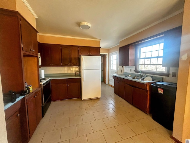 kitchen with white appliances, tasteful backsplash, ornamental molding, light countertops, and a sink