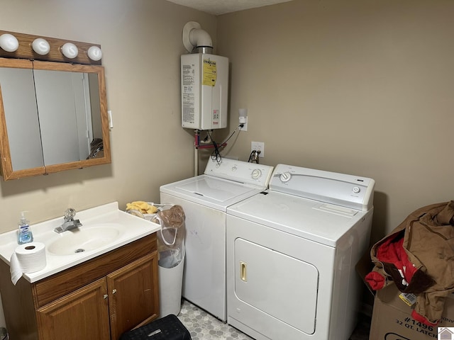 laundry room featuring laundry area, washing machine and dryer, water heater, and a sink