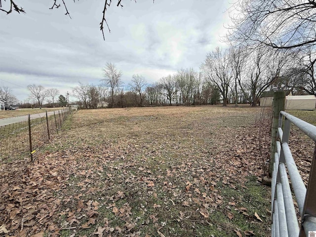 view of yard featuring a rural view and fence