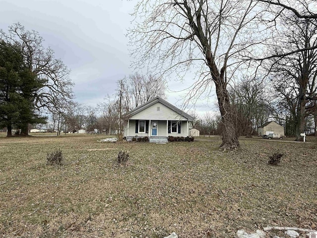 bungalow-style home featuring a porch and a front yard