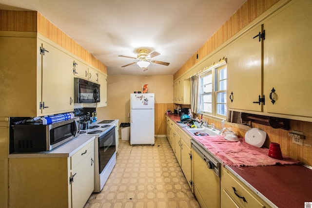 kitchen with black microwave, dishwashing machine, electric range, freestanding refrigerator, and stainless steel microwave