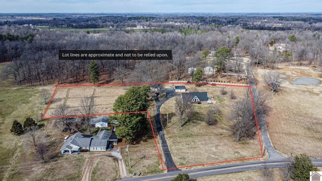 birds eye view of property featuring a view of trees