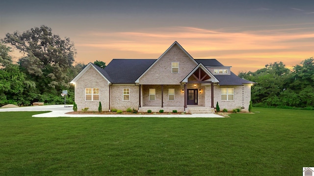 craftsman-style home with covered porch and a front lawn