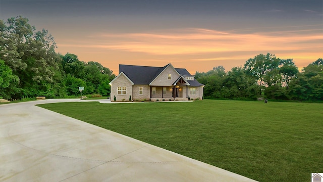 view of front of house with driveway and a front yard