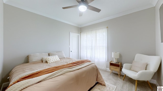 bedroom with a ceiling fan, light colored carpet, crown molding, and baseboards