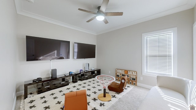 playroom featuring carpet floors, baseboards, ornamental molding, and a ceiling fan