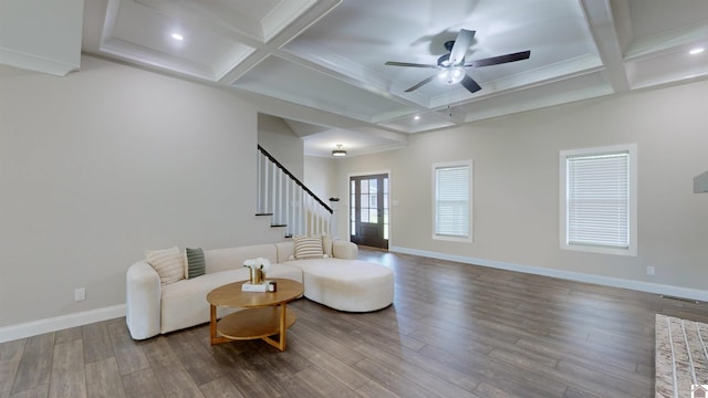 living room featuring baseboards, coffered ceiling, a ceiling fan, stairway, and wood finished floors