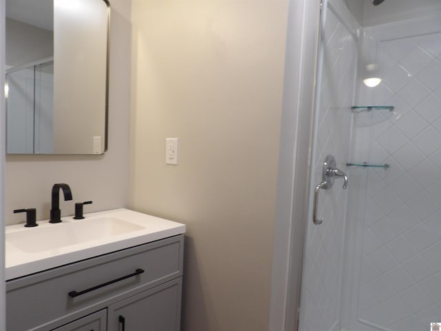 full bath with a stall shower and vanity