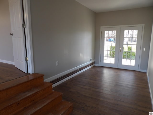 interior space with french doors, wood finished floors, and baseboards