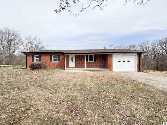 single story home featuring covered porch, concrete driveway, brick siding, and an attached garage