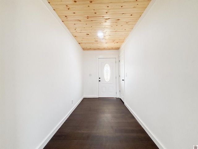 doorway featuring ornamental molding, dark wood-style flooring, wood ceiling, and baseboards