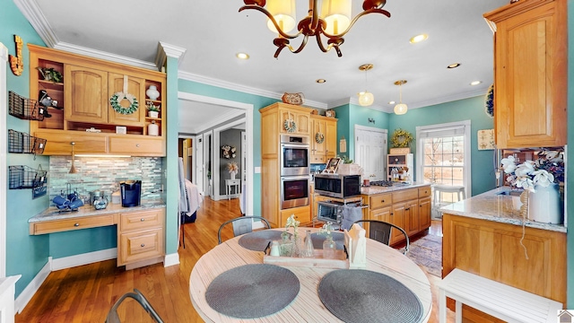 kitchen featuring stainless steel appliances, decorative backsplash, open shelves, light wood finished floors, and built in desk