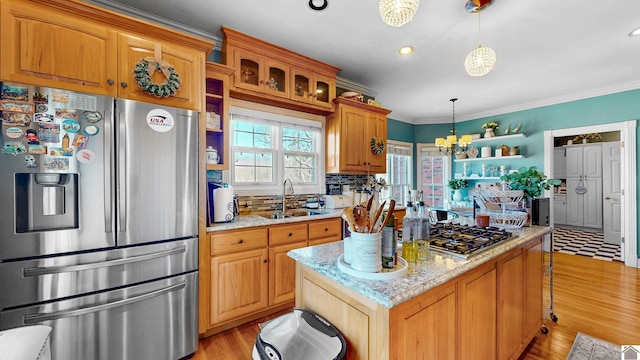 kitchen with decorative backsplash, an inviting chandelier, stainless steel appliances, crown molding, and a sink