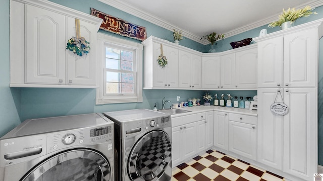 laundry area with crown molding, light floors, cabinet space, a sink, and washer and dryer