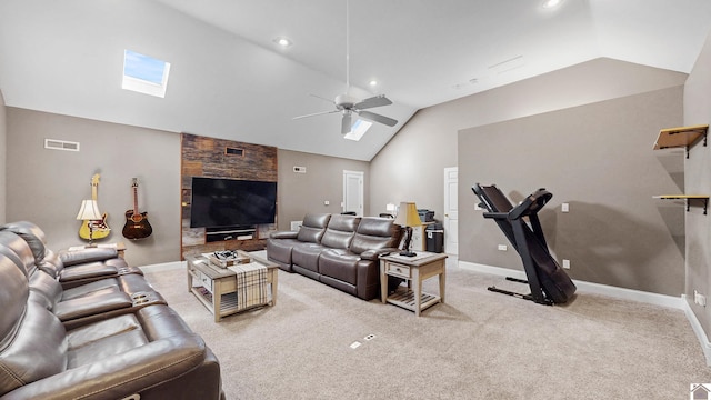 living area featuring visible vents, baseboards, a ceiling fan, lofted ceiling with skylight, and carpet