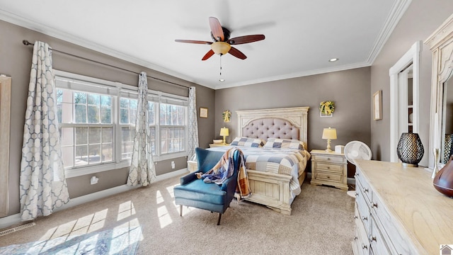 bedroom with baseboards, visible vents, light colored carpet, ceiling fan, and ornamental molding