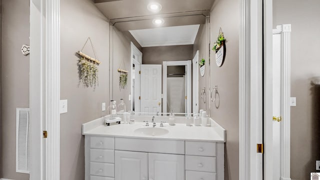 bathroom with recessed lighting, visible vents, crown molding, and vanity