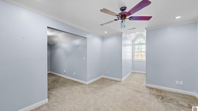 carpeted empty room featuring baseboards, ceiling fan, visible vents, and crown molding