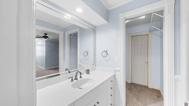 bathroom with baseboards, a ceiling fan, vanity, and crown molding