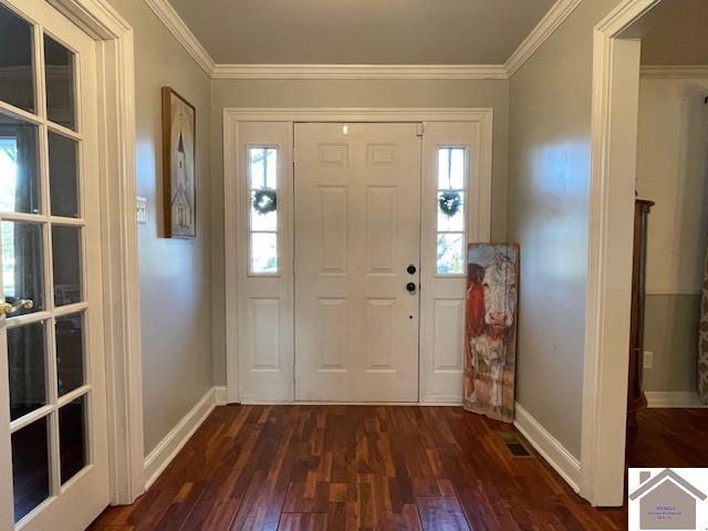 foyer with crown molding, dark wood finished floors, and baseboards