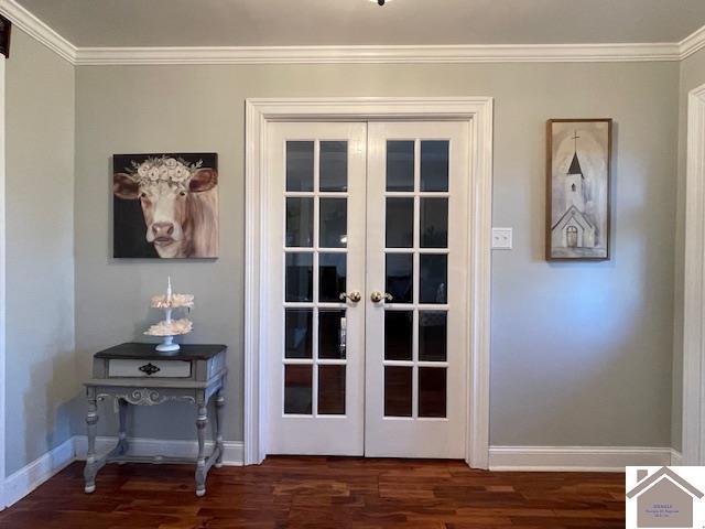 entryway with dark wood-type flooring, french doors, crown molding, and baseboards