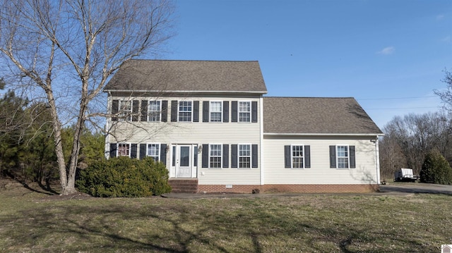 view of front facade featuring a shingled roof, entry steps, crawl space, and a front lawn