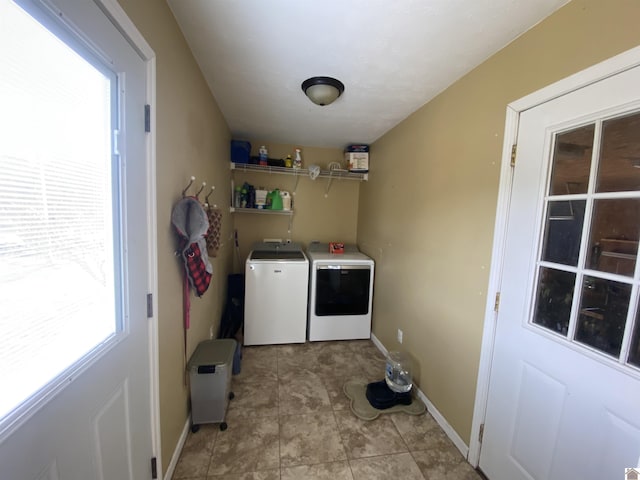 laundry area with baseboards, laundry area, and washer and dryer