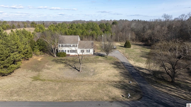 drone / aerial view with a wooded view