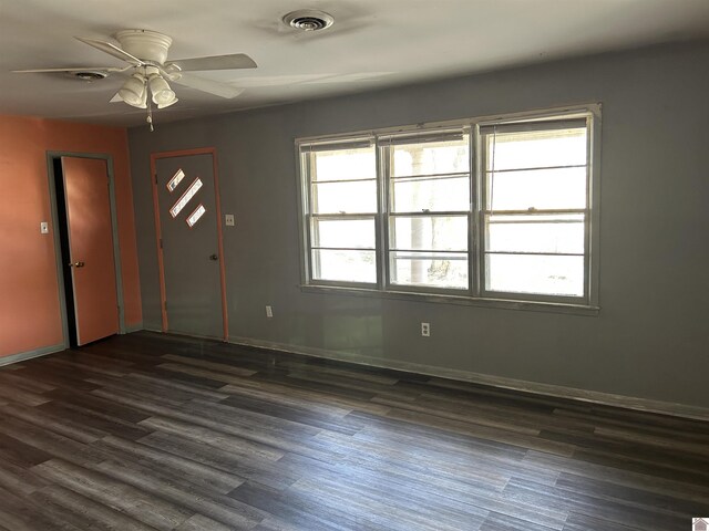 foyer featuring baseboards, visible vents, and dark wood-style flooring