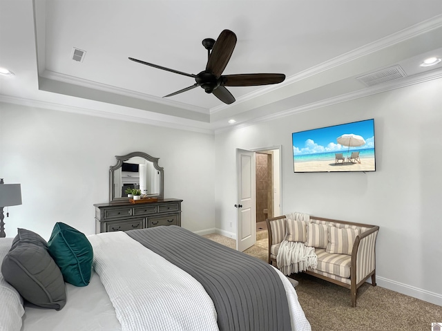 carpeted bedroom featuring ornamental molding, a tray ceiling, and visible vents