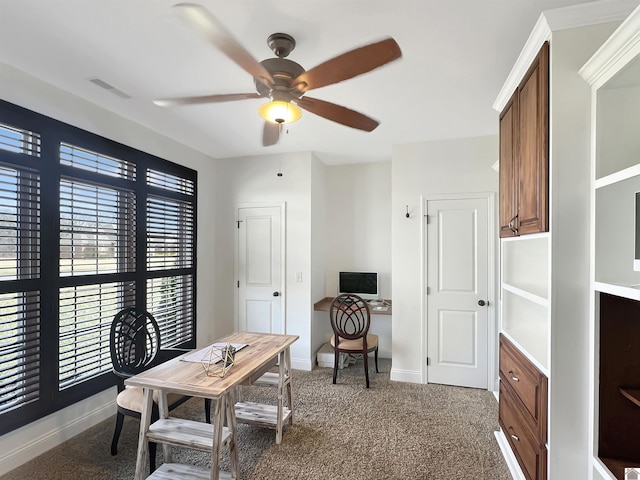 carpeted home office with ceiling fan, visible vents, and baseboards