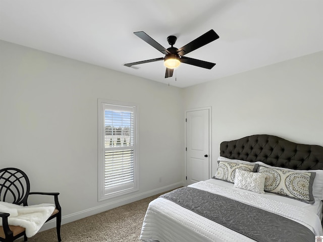 bedroom with ceiling fan, carpet flooring, and baseboards