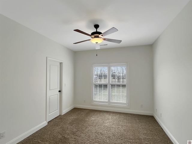 spare room featuring carpet floors, ceiling fan, and baseboards