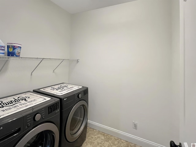 washroom featuring laundry area, independent washer and dryer, and baseboards