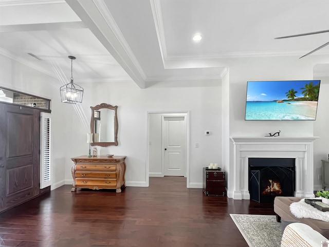 foyer entrance featuring crown molding, a lit fireplace, baseboards, and wood finished floors