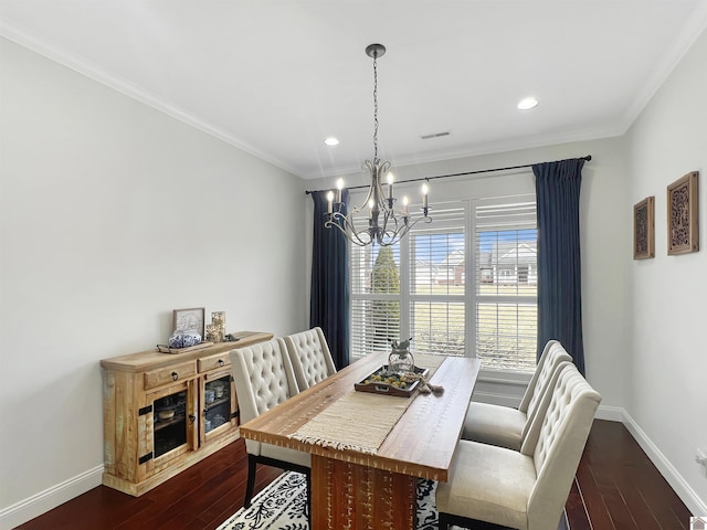 dining room with dark wood-type flooring, a chandelier, visible vents, and baseboards